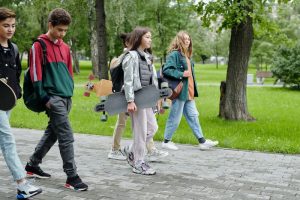 School kids walking on pavement to school